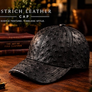 May include: A black baseball cap crafted from ostrich leather, featuring a distinctively textured surface with raised quill follicles. The cap displays the text OSTRICH LEATHER CAP, EXOTIC TEXTURE, TIMELESS STYLE, and icons for genuine leather, craftsmanship, comfort, and durability.