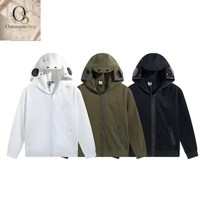 May include: Three zip-up hooded sweatshirts in white, olive green, and black. Each hoodie features a full-length front zipper, two side pockets, and integrated circular lenses on the hood. The garments have a solid color design.