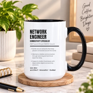 May include: A white ceramic mug with a black interior and handle, featuring black text that defines a network engineer as a connectivity specialist, including bullet points about building secure networks and maintaining communication.