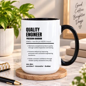 May include: A white ceramic mug with a black handle and interior, featuring black text that defines a Quality Engineer as a precision guardian, including a phonetic pronunciation and bulleted list of professional responsibilities.