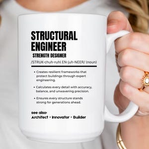May include: A white ceramic mug featuring black text that defines a structural engineer as a strength designer. The text includes a phonetic pronunciation, a three-bullet point description of engineering tasks, and a see also section with architect, innovator, and builder.
