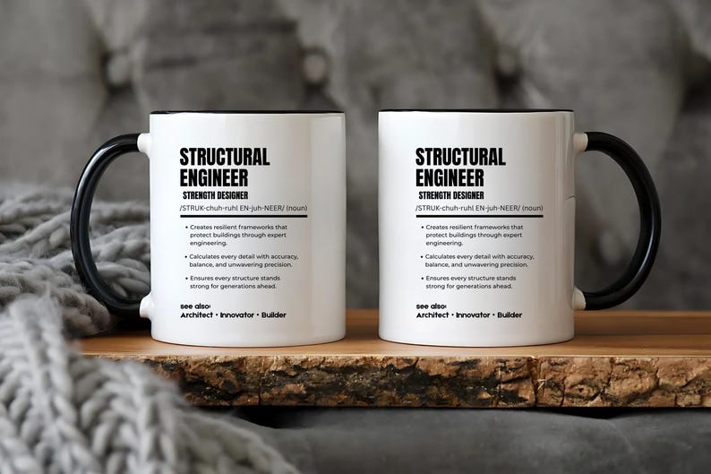 May include: Two white ceramic mugs with black handles and rims, each featuring a dictionary-style definition of a structural engineer. The text includes the title, phonetic pronunciation, and three bullet points describing engineering tasks.