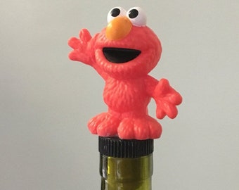 Red Character Bottle Stopper for a liquor or wine bottle.