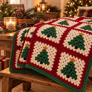 May include: A handmade crochet blanket featuring a repeating pattern of square motifs. Each square has a cream-colored background with a dark green Christmas tree centered in the middle, topped with a small yellow star, all bordered by red yarn.