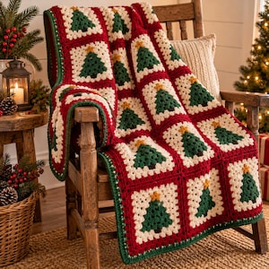 May include: A handmade crochet blanket featuring a repeating pattern of square motifs. Each square contains a dark green Christmas tree with a yellow star on top, set against a cream-colored background, all joined by deep red yarn borders.