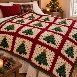 May include: A handmade crochet blanket featuring a repeating pattern of square motifs. Each square contains a dark green Christmas tree with a small yellow star on top, set against a cream-colored background, all joined by deep red borders.