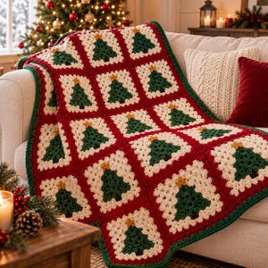 May include: A handmade crochet blanket featuring a repeating pattern of square motifs. Each square contains a dark green Christmas tree with a small yellow star on top, set against a cream-colored background, all bordered by deep red yarn.