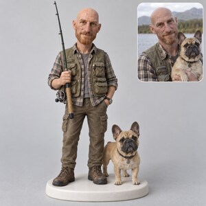 May include: A custom figurine of a bald man with a reddish beard wearing a plaid shirt, olive green utility vest, and cargo pants, holding a fishing rod. Beside him stands a tan French Bulldog with a black collar on a round white base.