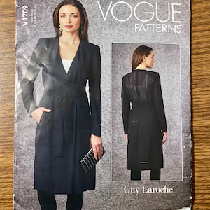 May include: Vogue Patterns V1709 sewing pattern envelope featuring a Guy Laroche design for a long, black, wrap-style coat with a tie waist, long sleeves, and a V-neckline. The front shows a model in the coat, while the back view is shown in an inset.