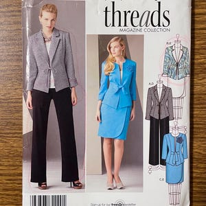 May include: Simplicity sewing pattern 2229, Threads Magazine Collection, size U5 16-24. The envelope displays two outfits: a black and white patterned blazer with black trousers, and a solid blue blazer with a matching wrap skirt and floral detail.