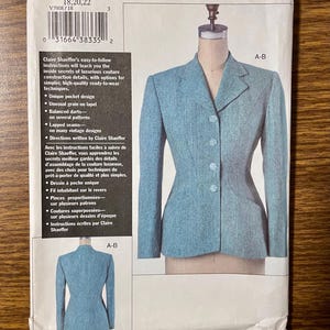 May include: A sewing pattern for a tailored jacket from the Claire Shaeffer Custom Couture Collection. The pattern features a light blue jacket on a mannequin, with a close-up of the jacket's details. The pattern includes instructions for unique pocket designs and lapped seams.
