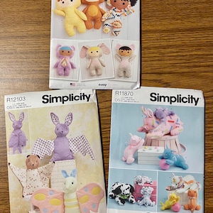 May include: Three Simplicity sewing pattern envelopes featuring various stuffed animal designs. The patterns include instructions for making plush toys such as bears, bunnies, and other creatures. The text "easy-to-sew" is visible on the patterns.