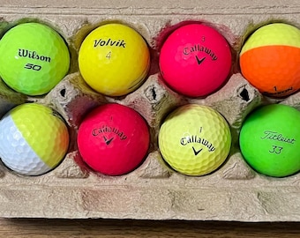 A dozen colorful used golf balls