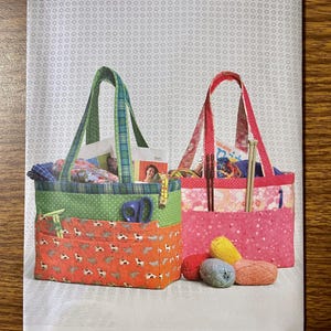 May include: A set of three ceramic mugs with a speckled, matte finish. The mugs are in shades of cream, light gray, and dark gray. Each mug has a simple, minimalist design and a rounded handle.