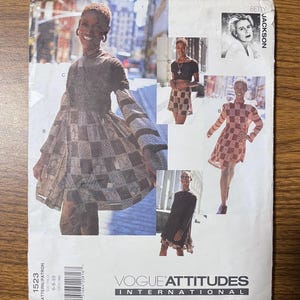 May include: Vogue Attitudes International sewing pattern 1523. The pattern features multiple images of a woman modeling various outfits. The outfits include dresses and a skirt set, all with a checkered pattern. The pattern cover also includes the name "Betty Jackson".