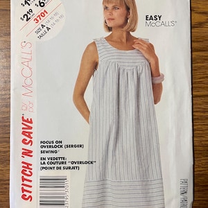 May include: A McCall's sewing pattern envelope for a sleeveless dress with a vertical striped pattern. The front displays the text Easy McCall's, Stitch 'N Save, and Focus on Overlock (Serger) Sewing. The pattern is labeled as Size A (14-16-18).