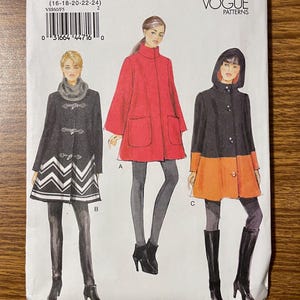 May include: Vogue Patterns sewing pattern V8860 for coats. The pattern features three coat designs: a black coat with a white chevron hem, a red coat, and a black and orange coat. The pattern size is F5 (16-18-20-22-24).