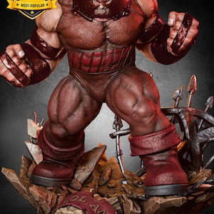 Op de afbeelding: Een gespierd Juggernaut-figuur in een donkerrood pak met een metalen helm, staand op een rotsachtige basis met een banner met de tekst "ANNIVERSARY". Een gouden badge linksboven toont de tekst "MOST POPULAR" met een sterpictogram.