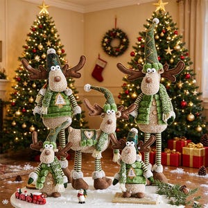 May include: A collection of four plush reindeer figurines with textured beige bodies, brown felt antlers, and green fabric hats and vests. The figures feature striped sleeves and legs, with some wearing scarves and decorative buttons, arranged on a white surface.