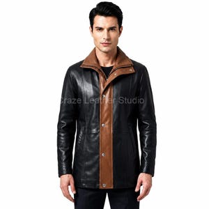 May include: A black leather jacket featuring a contrasting brown leather center panel and a matching brown fold-over collar. The jacket includes a front button closure with silver-toned hardware and vertical seam detailing. The text Craze Leather Studio is visible.