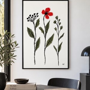 May include: A framed wall art print featuring a sketch-style illustration of three wildflowers on a white background. The central flower is bright red, while the two flanking plants are rendered in dark green and black ink lines. The artist signature Kall is visible in the bottom right corner.