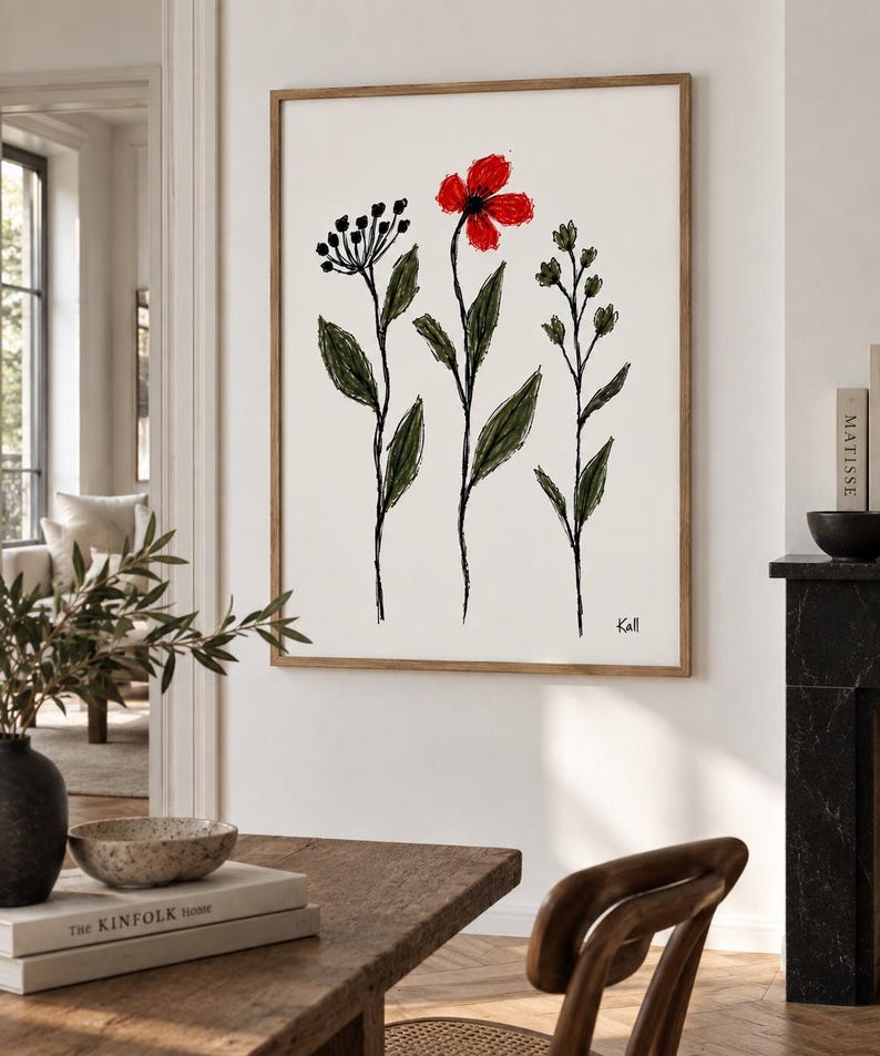May include: A framed wall art print featuring a minimalist sketch of three botanical stems on a white background. The central stem displays a vibrant red flower, while the others are rendered in black ink with green leaves. The signature Kall is visible.