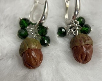 Handmade polymer clay earrings with autumn acorn design.