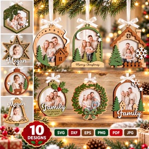 May include: A collection of ten wooden Christmas ornaments featuring various shapes like hexagons, stars, houses, and wreaths. Each ornament includes a photo frame, white ribbon hanger, and decorative elements like trees, snowflakes, and text.