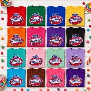 Puede incluir: Una colección de dieciséis camisetas de manga corta en varios colores sólidos, cada una con el logotipo de Dubble Bubble con un icono de corona y el texto America's Original Dubble Bubble impreso en un óvalo rojo en la parte frontal.