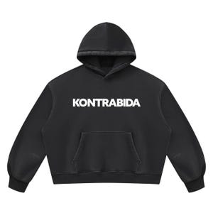 May include: A black long-sleeve hooded sweatshirt featuring the word KONTRABIDA printed in bold white capital letters across the chest. The garment includes a front kangaroo pocket, a drawstring-free hood, and ribbed cuffs at the sleeves and hem.