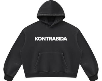 May include: A black long-sleeve hooded sweatshirt featuring the word KONTRABIDA printed in bold white capital letters across the chest. The garment includes a front kangaroo pocket, a drawstring-free hood, and ribbed cuffs at the sleeves and hem.