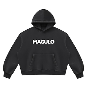 May include: A black long-sleeve hooded sweatshirt featuring the word MAGULO printed in bold white capital letters across the center of the chest. The garment includes a front kangaroo pocket, a drawstring-free hood, and ribbed cuffs.