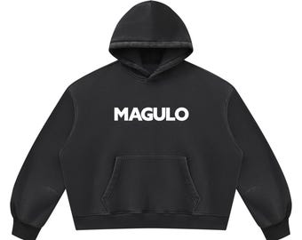 May include: A black long-sleeve hooded sweatshirt featuring the word MAGULO printed in bold white capital letters across the center of the chest. The garment includes a front kangaroo pocket, a drawstring-free hood, and ribbed cuffs.