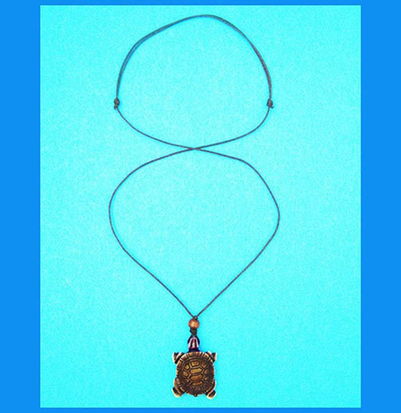 Protection. Turtle Pendant made of resin on black cotton cord Adjustable length; choker to long Necklace Symbol: Strength Unisex
