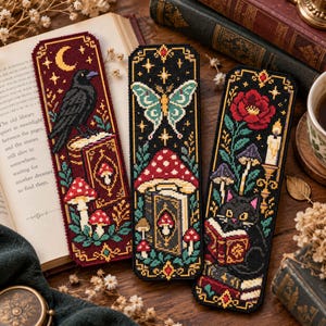 May include: Three rectangular cross-stitch bookmarks featuring detailed embroidery. The left shows a crow, moon, and mushrooms. The center displays a moth, mushroom, and book. The right depicts a black cat reading, a rose, and a candle.