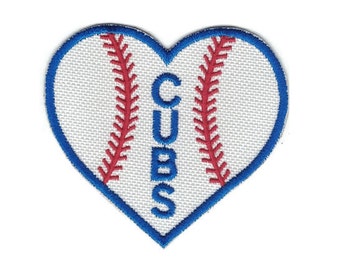 May include: White heart-shaped patch with a baseball design. The baseball has red stitching and a blue outline. The word "CUBS" is written vertically in blue letters.