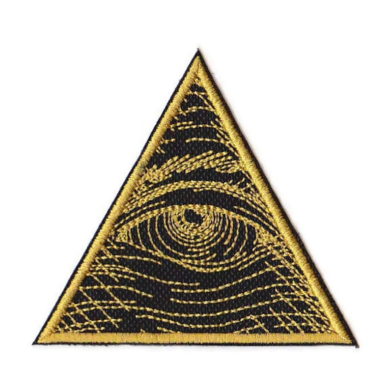 May include: A gold embroidered patch with a black eye inside a triangle.