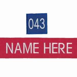 May include: Two embroidered patches: a red rectangular patch with "NAME HERE" in white, and a blue square patch with "043" in white. The patches are likely for uniforms or personalized items.