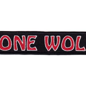 May include: Black and red embroidered patch with the text "LONE WOLF" in a stylized font.