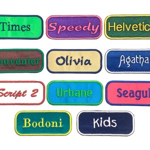 May include: Ten colorful fabric patches with different font names, including Times, Speedy, Helvetica, Souvenir, Olivia, Agatha, Script 2, Urbane, Seagul, Bodoni, and Kids.