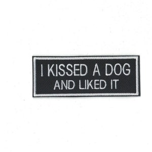 May include: Black and white embroidered patch with the text "I kissed a dog and liked it".