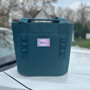 May include: A rustic wooden sign with the text "Welcome to our home" in white lettering. The sign features a distressed finish and a simple, inviting design, perfect for entryway decor.