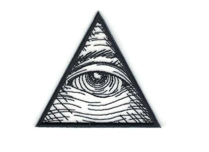 May include: Black and white embroidered patch of an eye inside a triangle. The eye is detailed with lines and shading.