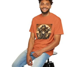May include: A burnt orange short-sleeve t-shirt featuring a graphic print of a turtle wearing a helmet and sunglasses while riding a motorcycle. The illustration is rendered in sepia tones and depicts the turtle on a road against a large sun.