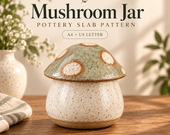 May include: A ceramic mushroom-shaped jar with a speckled cream base and a sage green cap featuring white spots. The text PotteryDigga Mushroom Jar Pottery Slab Pattern A4 + US Letter Digital Download is visible in the background of the image.