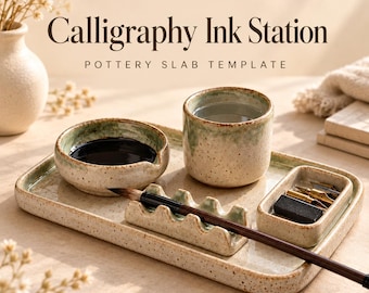 May include: A ceramic calligraphy ink station set featuring a rectangular tray, a small ink bowl, a water cup, a brush rest, and a rectangular pen holder. The pieces are speckled beige with green glazed rims. Text reads PotteryDigga Calligraphy Ink Station.
