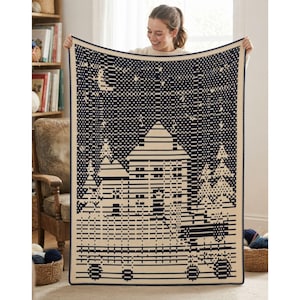 May include: A rectangular crochet blanket featuring a dark navy blue and cream color scheme. The design depicts a winter scene with a central house, surrounding pine trees, and a night sky filled with stars and a crescent moon pattern.