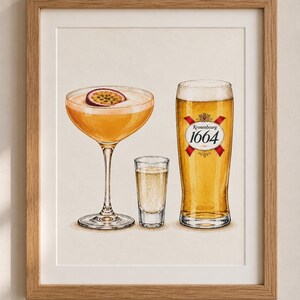May include: A framed art print featuring a watercolour illustration of a passion fruit martini with a fruit slice garnish, a small shot glass of clear liquid, and a tall glass of golden beer labelled with the Kronenbourg 1664 logo and red ribbons.