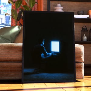 May include: A framed rectangular wall art print featuring a silhouette of a person sitting in a dark room, illuminated only by the bright blue glow of a computer monitor. The person is positioned at a desk, facing the screen in a dim setting.