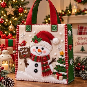 May include: A cream-colored felt tote bag featuring a snowman wearing a red hat and plaid scarf, a green Christmas tree, and a sign that reads Let it Snow. The bag has red and green handles, white snowflake accents, and red stitched edges.
